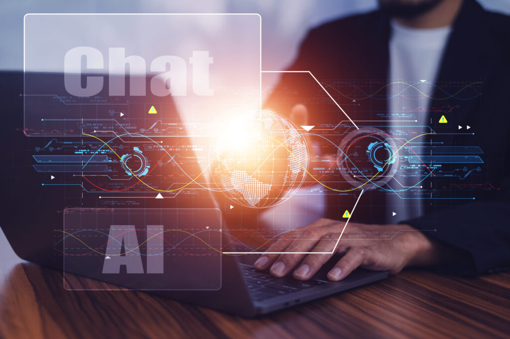 ChatGPTのコンセプト、コンピューターを使用する人々、ノートパソコンのキーボードで入力する横からの視点、AIまたは人工知能とのChatGPTチャット。ChatGPTのコンセプト